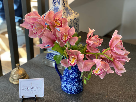 Orchids in a blue pitcher